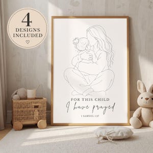 May include: A framed wall art print featuring a black line drawing of a person holding a child. The text reads: 4 DESIGNS INCLUDED, FOR THIS CHILD I have prayed, 1 SAMUEL 1:27. The artwork is displayed in a light wood frame against a neutral background.
