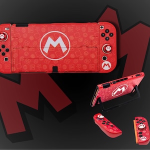 May include: Red Nintendo Switch console and controllers featuring a white "M" logo and icon pattern. The console is displayed in various positions, including with a stand and separate controllers. The background is dark grey with a red "M" logo.