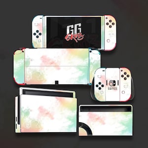 May include: A collection of Nintendo Switch skins featuring a watercolor design in pastel colors. The skins cover the console, Joy-Cons, and dock. The screen displays "GG Skins" in red. The Nintendo Switch logo is visible.