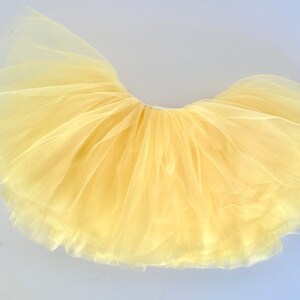 Our New Yellow full-layer tutu is perfect for birthdays, every day, spring, or weddings! The buttery lemon yellow tulle is so pretty. A wide waist band keeps it comfortable and snug on the body but not too tight.