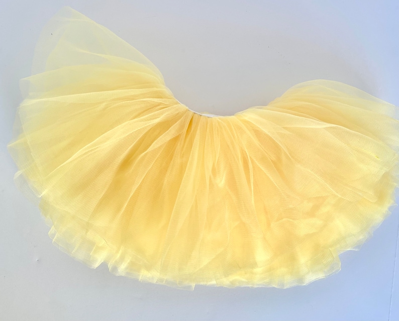 Our New Yellow full-layer tutu is perfect for birthdays, every day, spring, or weddings! The buttery lemon yellow tulle is so pretty. A wide waist band keeps it comfortable and snug on the body but not too tight.