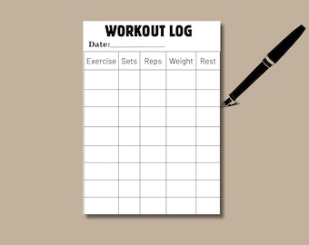 May include: A white Workout Log sheet with a black pen. The sheet has a grid for tracking exercise, sets, reps, weight, and rest. The title "WORKOUT LOG" is at the top. The pen is black with a silver tip.