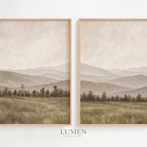 May include: Two vertical framed wall art prints featuring a landscape painting of a grassy field in the foreground, a line of trees in the mid-ground, and layers of hazy, muted beige and brown mountains under a cloudy sky in the background.