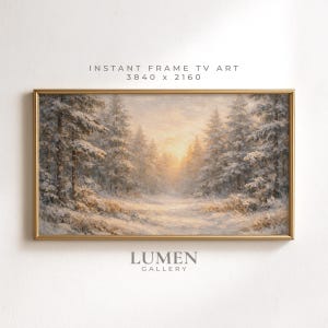 May include: A rectangular digital artwork for a television screen in a gold frame, depicting a snowy forest landscape with pine trees covered in snow and a soft golden sunset glow. The text INSTANT FRAME TV ART 3840 x 2160 and LUMEN GALLERY appear.