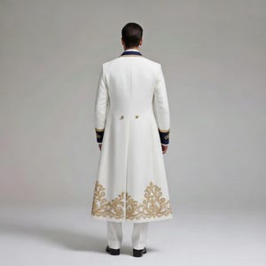 May include: A white formal coat with gold embroidery along the bottom hem and sleeve cuffs. The coat has a navy blue collar and sleeve accents. The back of the coat is visible, showing a tailored fit and decorative buttons.