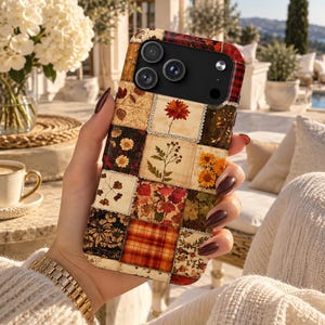May include: A smartphone case featuring a patchwork design of various autumn-themed patterns, including pressed flowers, red and orange leaves, and plaid squares. The case has a black camera cutout area and a glossy finish over the printed design.
