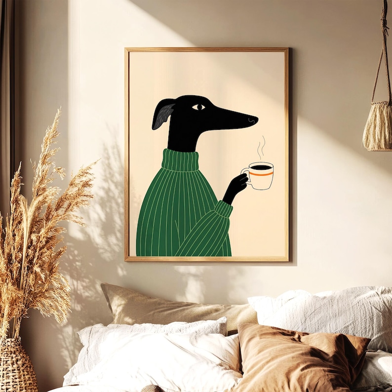 May include: A framed art print depicting a black dog in a green sweater, holding a coffee cup. The dog has a long snout and is illustrated in a minimalist style. The background is a light beige, and the frame is natural wood. A modern home decor item.