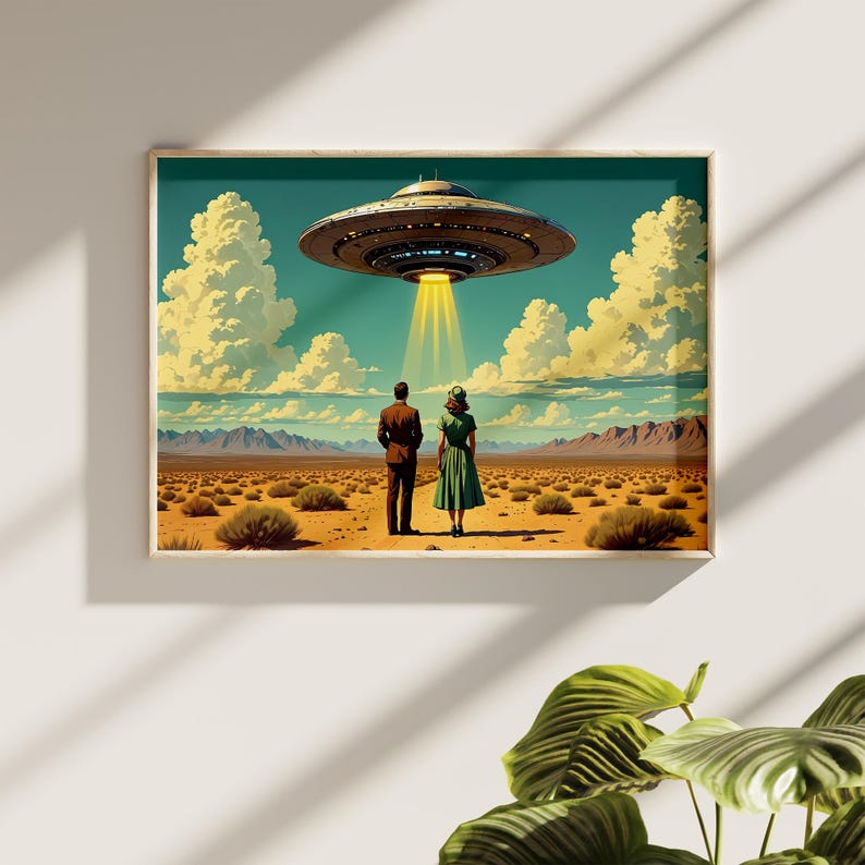 May include: A framed art print depicts a retro-style scene of a couple standing in a desert landscape, gazing at a hovering UFO. The artwork features a teal sky, fluffy clouds, and a beam of light shining down from the spacecraft.