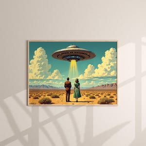 May include: A framed art print depicting a retro scene of a couple gazing at a hovering UFO. The artwork features a desert landscape with a blue sky, fluffy clouds, and a beam of light shining down from the spacecraft.