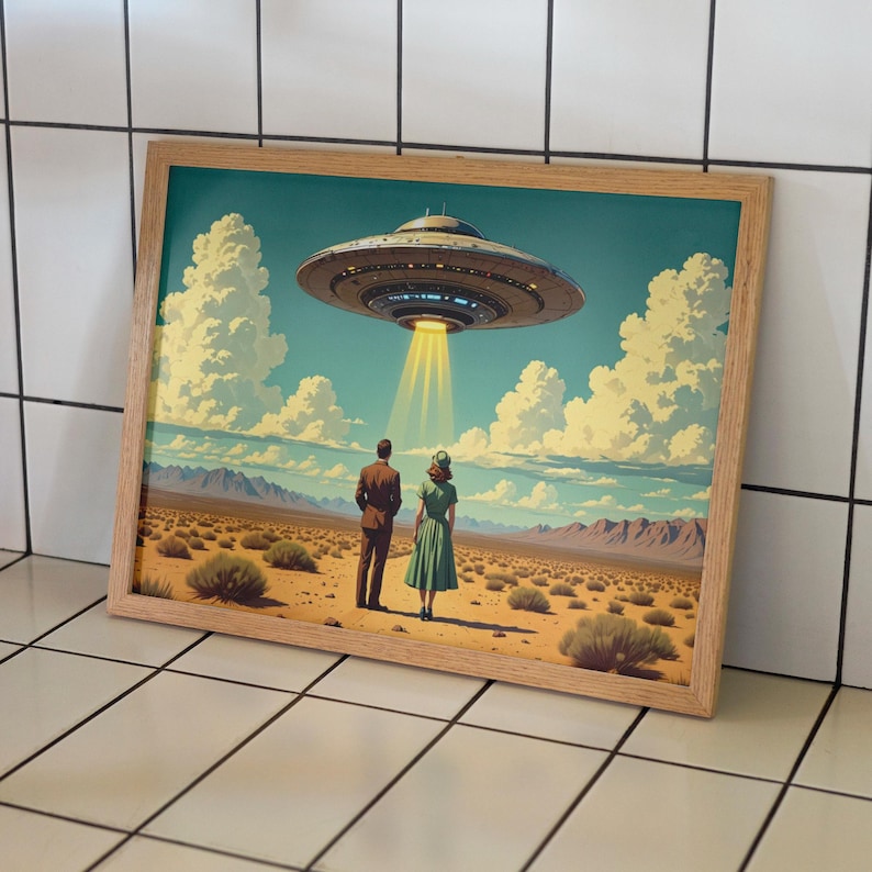 May include: Framed art print depicting a retro scene of a couple gazing at a hovering UFO. The artwork features a desert landscape under a cloudy sky, with the spacecraft emitting a beam of light. The frame is made of light-colored wood.