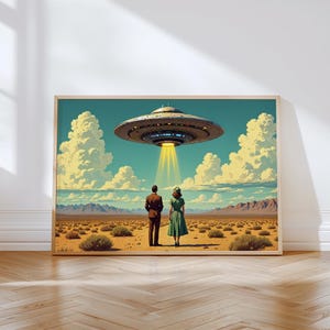 May include: A framed art print depicts a retro scene of a couple gazing at a hovering UFO. The artwork features a desert landscape under a blue sky with fluffy clouds. The UFO emits a bright yellow beam of light.