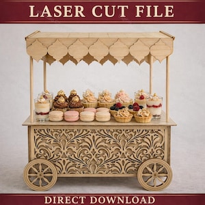 May include: A laser-cut wooden dessert cart with a decorative floral design on the front and sides. The cart features a canopy and is filled with various desserts, including cupcakes, tarts, macarons, and parfaits. The text "LASER CUT FILE" and "DIRECT DOWNLOAD" are visible.