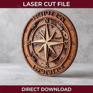 May include: A laser-cut wooden compass rose with a detailed topographic map design. The compass features a central star, cardinal directions, and coordinates. The text "LASER CUT FILE" and "DIRECT DOWNLOAD" are visible.