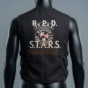 May include: A black tactical vest featuring a printed R.P.D. S.T.A.R.S. Raccoon Police Department emblem on the back. The design includes three white stars within a circular logo, the text S.T.A.R.S., and the word IBRAFORGE printed in brown below.