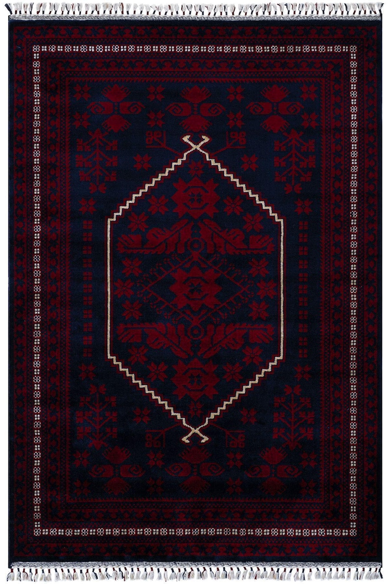 May include: A rectangular, dark blue rug with a central geometric design in deep red. The rug features a white, zigzag border and intricate floral patterns. The edges are finished with a fringe.