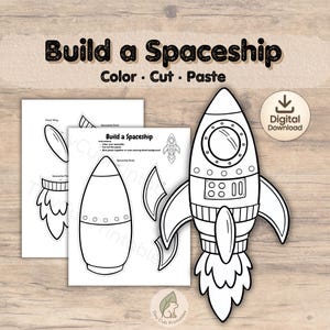 May include: A black and white printable craft kit with the text "Build a Spaceship" and instructions to color, cut, and paste. The kit includes spaceship parts and a digital download icon.