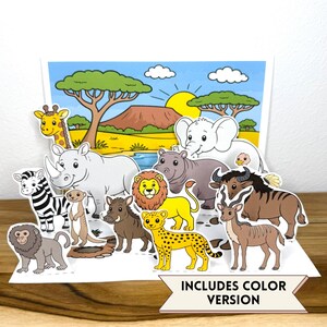 May include: A pop-up display featuring cartoon illustrations of a giraffe, zebra, rhino, meerkat, warthog, lion, cheetah, elephant, hippo, wildebeest, and antelope against a savanna backdrop. A banner at the bottom reads INCLUDES COLOR VERSION.