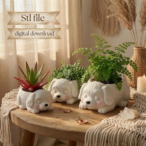 May include: Three white ceramic dog-shaped planters with pink cheeks, each holding a green plant. The text Stl file digital download is visible in the upper left corner. The planters are resting on a wooden surface with a textured fabric runner.