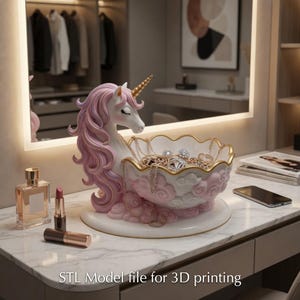 May include: A pink and white unicorn-shaped jewelry holder with a gold horn and rim. The holder is filled with necklaces and rings. The base is white, and the text "STL Model file for 3D printing" is at the bottom.