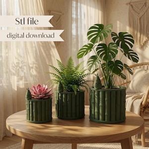 May include: Three cylindrical dark green planters with a bamboo-like texture, each featuring a small decorative bamboo shoot figurine on the rim. The planters hold a pink succulent, a green fern, and a large monstera plant. Text reads Stl file digital download.