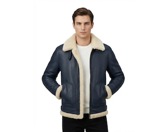 May include: A navy blue leather jacket with a cream-colored shearling collar and lining. The jacket features two front pockets, a buckle detail at the waist, and shearling trim on the cuffs. A classic winter coat.