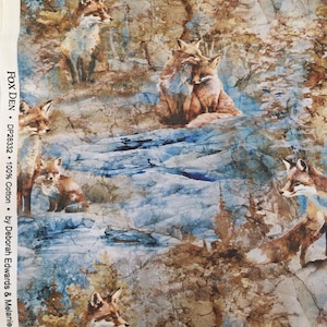 May include: Fabric with a repeating pattern of foxes in a forest setting. The foxes are depicted in shades of brown, orange, and white against a backdrop of blue, brown, and tan. The text "FOX DEN" is visible.