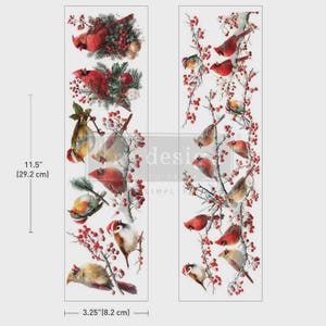 May include: Two vertical decorative transfer sheets featuring red cardinals perched on snowy branches with red berries. The sheets measure 11.5 inches by 3.25 inches. The design includes multiple birds in various poses amidst winter foliage and berries.
