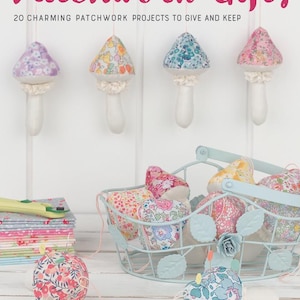 May include: A book titled Patchwork Gifts: 20 Charming Patchwork Projects to Give and Keep by Elise Baek. The cover features fabric mushrooms in floral patterns, a light blue wire basket, and a stack of colorful fabric squares with a rotary cutter.