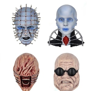 May include: Four horror movie masks. The top left mask is blue with metal pins. The top right mask is pale blue with a black collar. The bottom left mask is red and brown with a cage-like design. The bottom right mask is tan with black round glasses.