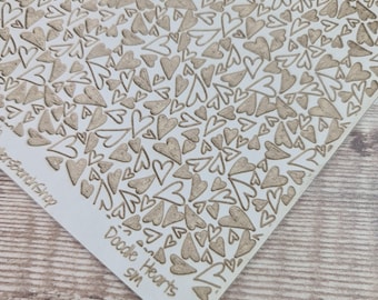 May include: A wooden craft panel with a repeating pattern of carved hearts. The hearts are in various sizes and orientations, creating a textured surface. The words "Doodle Hearts" and "sm" are visible in the corner.