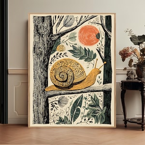May include: A framed wall art print featuring a stylized snail with a textured, patterned shell crawling along a tree branch. The illustration uses a palette of black, cream, orange, and muted green, depicting a forest scene with trees and foliage.