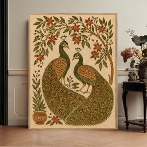May include: A rectangular wall art print featuring two peacocks with detailed green and gold plumage standing beneath a leafy tree with red flowers. A small potted plant sits in the lower left corner, all set against a light cream background.