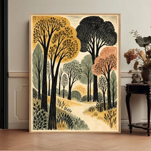 May include: A framed rectangular wall art print featuring a stylized forest landscape with black tree trunks and foliage in shades of mustard yellow, sage green, and muted orange. A light-colored path winds through the center of the trees.
