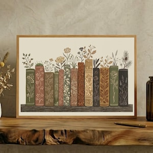 May include: A rectangular wall art print featuring a row of twelve vertical book spines in shades of green, brown, and cream. Each book spine is decorated with detailed line art illustrations of various wildflowers, leaves, and botanical stems.
