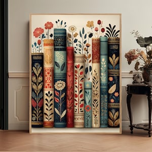 May include: A framed art print depicting a row of decorative books with floral designs. The spines feature patterns in red, blue, gold, and cream. The artwork has a vintage feel, with a focus on botanical and artistic elements.