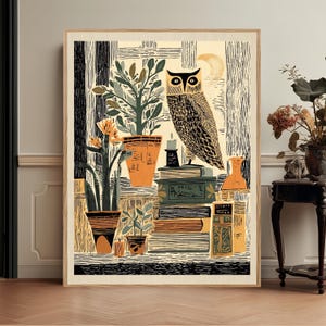 May include: A framed art print featuring a stylized illustration of an owl perched on a stack of books, surrounded by potted plants and candles. The color palette includes shades of black, cream, and muted orange, with a crescent moon in the background.