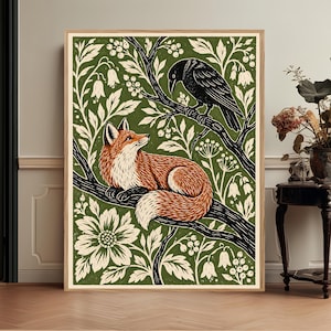 May include: A framed wall art print featuring a stylized illustration of a red fox resting on a tree branch with a black raven perched above. The design includes cream-colored floral and berry patterns set against a deep olive green background.