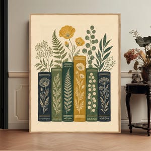 May include: A framed vertical art print featuring a row of six upright books in shades of dark blue, green, and yellow. Each book spine is decorated with botanical illustrations of ferns, poppies, and eucalyptus leaves extending upward.