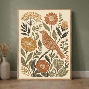 May include: A rectangular wall art print featuring a central brown bird perched on a branch, surrounded by stylized flowers and foliage in shades of terracotta, mustard yellow, and dark olive green on a cream-colored background in a wooden frame.