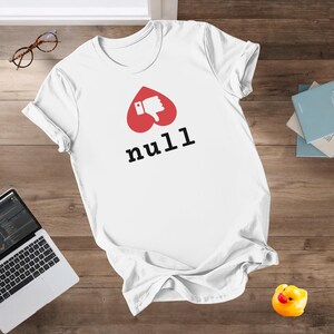 May include: White t-shirt with a red heart-shaped graphic showing a thumbs-down and the word "null" in black. The shirt is made of a soft material, likely cotton. The design is centered on the chest.