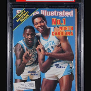 May include: A graded Sports Illustrated magazine cover featuring Michael Jordan and Sam Perkins in North Carolina basketball uniforms. The cover reads "No. 1 North Carolina" and "College Basketball Preview."