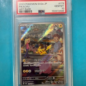May include: A graded Pok&eacute;mon trading card featuring Pikachu, an Art Rare from the 2023 SV2a JP set. The card displays a colorful illustration of Pikachu with other characters. The card is encased in a protective holder.