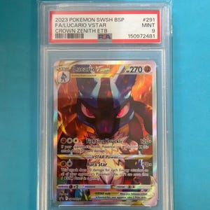 May include: A graded Pok&eacute;mon card featuring Lucario VSTAR from the Crown Zenith set. The card is encased in a protective holder with the text "2023 POKEMON SWSH BSP" and "FA/LUCARIO VSTAR". The card is graded as "MINT 9".