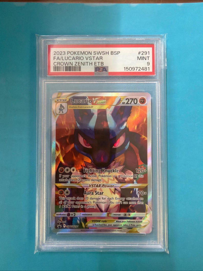 May include: A graded Pok&eacute;mon card featuring Lucario VSTAR from the Crown Zenith set. The card is encased in a protective holder with the text "2023 POKEMON SWSH BSP" and "FA/LUCARIO VSTAR". The card is graded as "MINT 9".