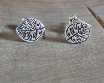 Silver monstera leaf stud earrings.