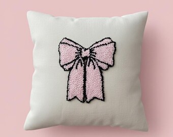 Capa de almofada rosa com laço e bordado em ponto de punção