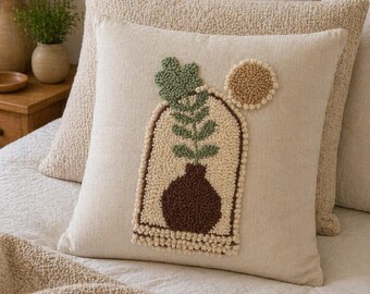 Funda de almohada con diseño de planta en maceta y aguja perforadora