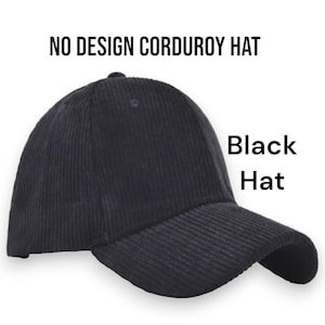 May include: A black corduroy hat with a curved brim. The hat has a classic baseball cap design and features the text "NO DESIGN CORDUROY HAT" and "Black Hat". The hat is made of a ribbed corduroy fabric.