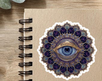 May include: A circular sticker featuring a central blue eye surrounded by intricate, layered mandala patterns in shades of deep purple, gold, and teal. The design is symmetrical, with ornate, petal-like shapes radiating outward from the eye.