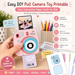 May include: A pink DIY pull camera toy printable with a blue and white lens, and the text "SAY CHEESE!". The printable includes a pull-out photo and instructions. The text on the image says "Fun Hands-on Learning!" and "Best Buddy".